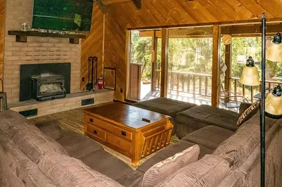a living room with a couch and a fireplace at The Badger House in Badger