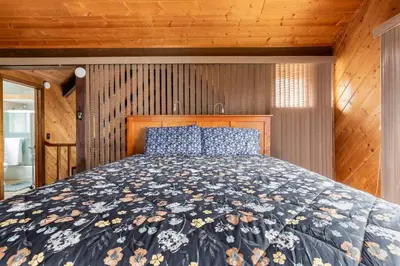 a bedroom with a bed with a floral bedspread at The Badger House in Badger