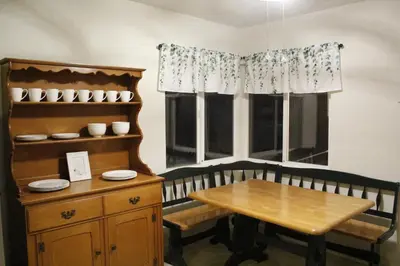 a dining room with a table and a window at Hummingbird Hill - Entire Cabin in Dunlap