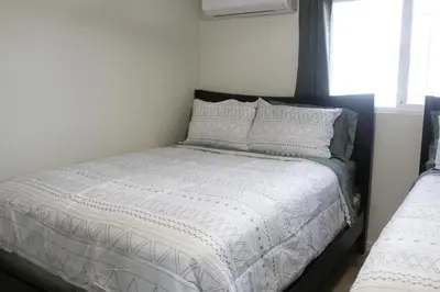 a bed with white sheets and pillows in a bedroom at Hummingbird Hill - Entire Cabin in Dunlap