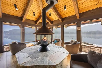 a large living room with a stone table and chairs at Charming Studio Deluxe w/kitchen #215 at Donner Lake Village in Truckee