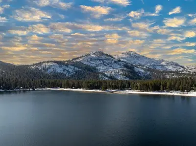 a view of a lake with snow capped mountains at Striking Queen Deluxe Studio w/Kitchenette #114 at Donner Lake Village in Truckee