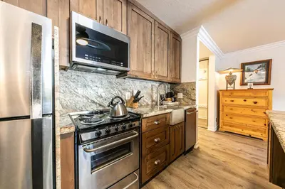 a kitchen with a stainless steel stove and a refrigerator at Charming Studio Deluxe w/Full Kitchen #115 at Donner Lake Village in Truckee