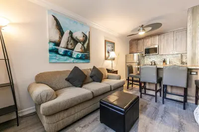 a living room with a couch and a kitchen at Charming Studio Deluxe w/Full Kitchen #115 at Donner Lake Village in Truckee
