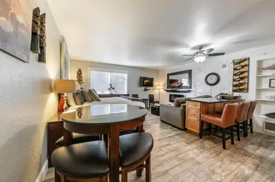 a living room with a bed and a dining room at Partial Lake View Stunning Deluxe King Studio #125 at Donner Lake Village in Truckee