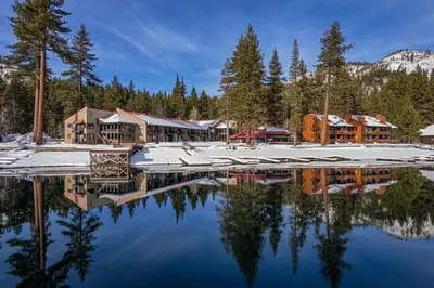 a resort with a reflection in the water at Cozy Deluxe Studio #131 at Donner Lake Village in Truckee