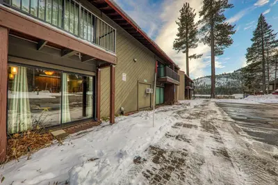 a snow covered street in front of a building at Cozy Studio 1st Floor #132 at Donner Lake Village in Truckee