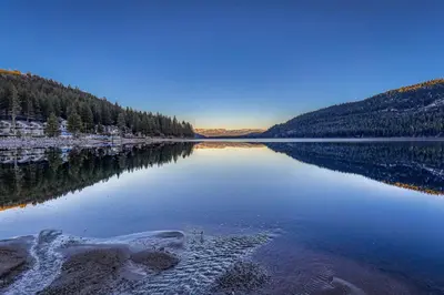 a large body of water with trees on the shore at Cozy Studio 1st Floor #132 at Donner Lake Village in Truckee