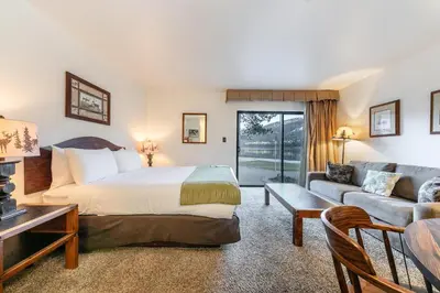 a hotel room with a bed and a couch at Quiant Studio w/Lake View #144 at Donner Lake Village in Truckee