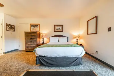 a bedroom with a large bed and two lamps at Quiant Studio w/Lake View #144 at Donner Lake Village in Truckee