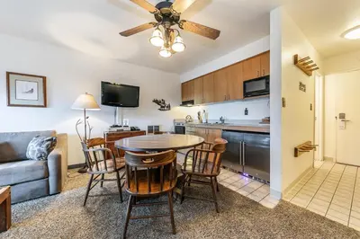 a kitchen and living room with a table and chairs at Quiant Studio w/Lake View #144 at Donner Lake Village in Truckee