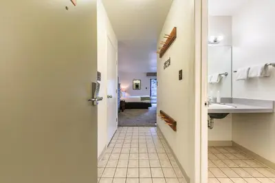 a hallway leading into a hotel room with a bathroom at Quiant Studio w/Lake View #144 at Donner Lake Village in Truckee