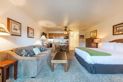 a hotel room with a bed and a couch at Quiant Studio w/Lake View #144 at Donner Lake Village in Truckee