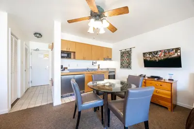 a kitchen and dining room with a table and chairs at Cozy King Studio w/Lake View #145 at Donner Lake Village in Truckee