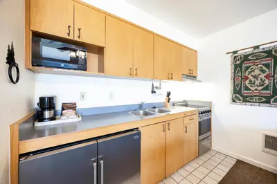 a small kitchen with a sink and a microwave at Cozy King Studio w/Lake View #145 at Donner Lake Village in Truckee