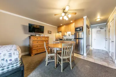 a kitchen and dining room with a table and chairs at Quaint Studio w/Lake View #146 at Donner Lake Village in Truckee