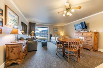 a living room with a table and a bedroom at Quaint Studio w/Lake View #146 at Donner Lake Village in Truckee