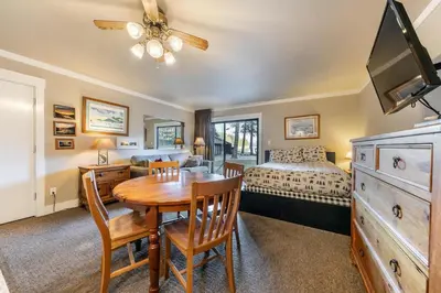 a bedroom with a dining room table and a bed at Quaint Studio w/Lake View #146 at Donner Lake Village in Truckee