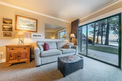 a living room with a couch and a table at Quaint Studio w/Lake View #146 at Donner Lake Village in Truckee