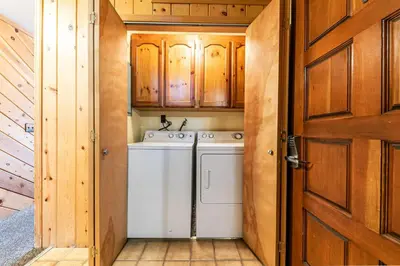 a washer and dryer in a bathroom with a door at Comfortable Townhouse w/Lake View #154 at Donner Lake Village in Truckee