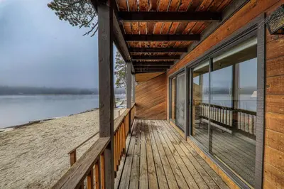a wooden porch of a house on the beach at Comfortable Townhouse w/Lake View #154 at Donner Lake Village in Truckee