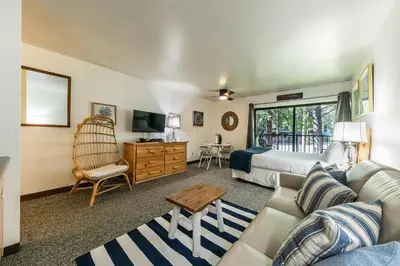a living room with a couch and a bed at Modern Studio w/Balcony #211 at Donner Lake Village in Truckee