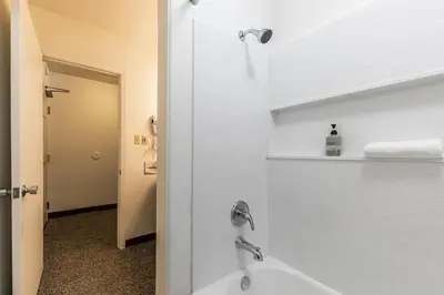 a bathroom with a shower and a tub and a sink at Modern Studio w/Balcony #211 at Donner Lake Village in Truckee