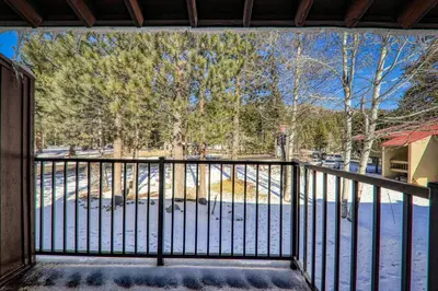 a balcony with a gate with snow on the ground at Cozy Studio w/Kitchenette and Balcony #212 at Donner Lake Village in Truckee