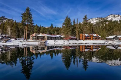 a reflection of a lodge in a lake with snow at Cozy Studio w/Kitchenette and Balcony #212 at Donner Lake Village in Truckee