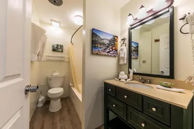 a bathroom with a sink and a toilet and a mirror at Cozy Studio w/Kitchenette and Balcony #212 at Donner Lake Village in Truckee