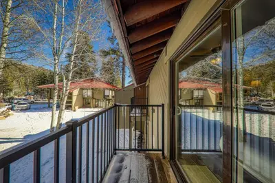 a balcony of a house with snow on the ground at Cozy Studio w/Kitchenette and Balcony #212 at Donner Lake Village in Truckee