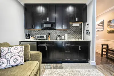 a kitchen with black cabinets and a couch in a living room at King Deluxe Studio 2nd Floor Unit 216 Bldg B in Truckee