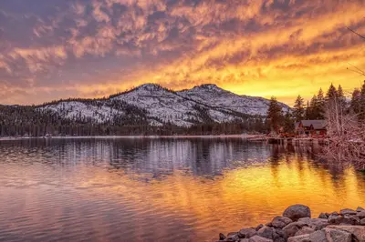 a sunset over a lake with snow covered mountains at King Deluxe Studio 2nd Floor Unit 216 Bldg B in Truckee