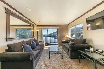 a living room with a couch and a table at Spacious Condo w/Lake View #247 at Donner Lake Village in Truckee