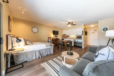 a bedroom with a bed and a living room at Charming Deluxe Studio w/Lake View #246 at Donner Lake Village in Truckee
