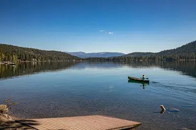 a person in a boat on a lake at Charming Deluxe Studio w/Lake View #246 at Donner Lake Village in Truckee