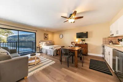 a large living room with a bed and a kitchen at Charming Deluxe Studio w/Lake View #246 at Donner Lake Village in Truckee