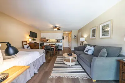 a living room with a couch and a table at Charming Deluxe Studio w/Lake View #246 at Donner Lake Village in Truckee