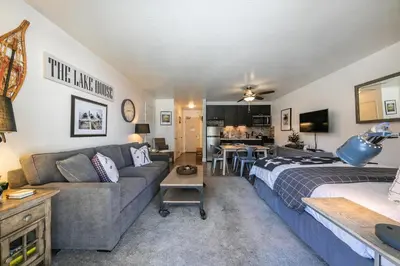 a living room with a bed and a couch at Beautiful Deluxe Studio w/Lake View #245 at Donner Lake Village in Truckee