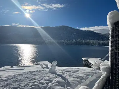 a snowman on a dock in front of a lake at Beautiful Deluxe Studio w/Lake View #245 at Donner Lake Village in Truckee