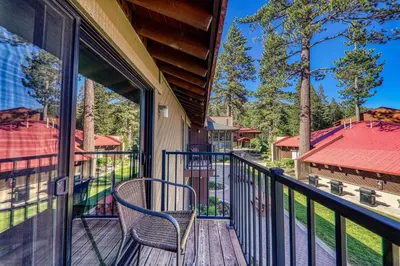 a balcony with a chair on a house at Striking Studio w/Lake View #244 at Donner Lake Village in Truckee