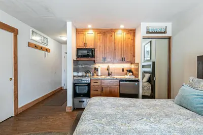 a kitchen with wooden cabinets and a stove top oven at Beautiful Studio w/ Lake View #243 at Donner Lake Village in Truckee