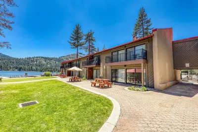 an exterior view of a building with a lawn and tables at Beautiful Studio w/ Lake View #243 at Donner Lake Village in Truckee
