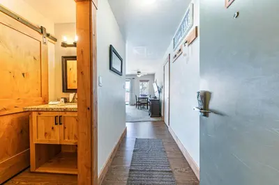 a hallway of a house with a door and a table at Beautiful Studio w/ Lake View #243 at Donner Lake Village in Truckee