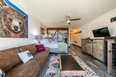 a living room with a couch and a bed at Striking King Studio w/Partial Lake View #242 at Donner Lake Village in Truckee