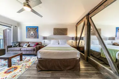 a bedroom with a bed and a couch at Striking King Studio w/Partial Lake View #242 at Donner Lake Village in Truckee