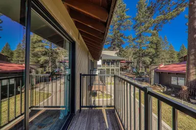 a balcony with a view of a yard at Striking King Studio w/Partial Lake View #242 at Donner Lake Village in Truckee