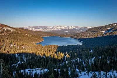 a lake in the middle of a mountain with trees at King Studio 2nd Floor #234 at Donner Lake Village in Truckee