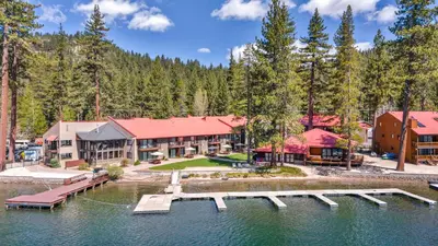 an image of a resort with a dock in the water at Charming Queen Studio Deluxe w/Balcony #233 at Donner Lake Village in Truckee