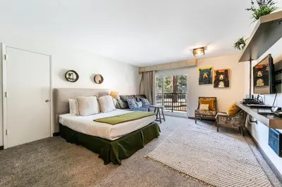 a bedroom with a bed and a living room at Modern Studio Deluxe #231 at Donner Lake Village in Truckee